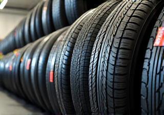 Selection of car and motorcycle tires stacked neatly